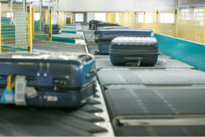 Picture of airline baggage on conveyor belt being processed by VTC equipment